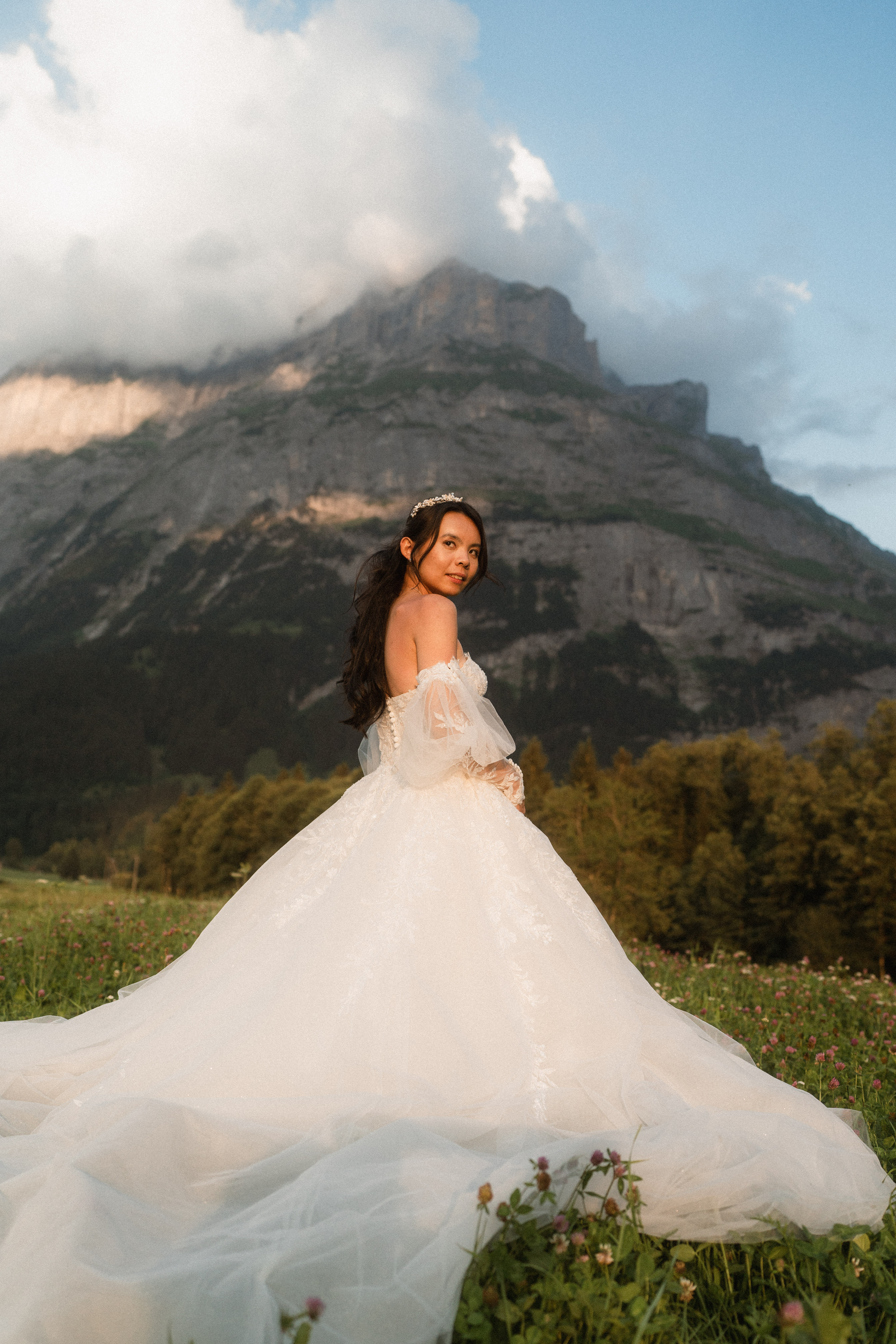 Jocelyn in her wedding dress against an Alpine mountain landscape