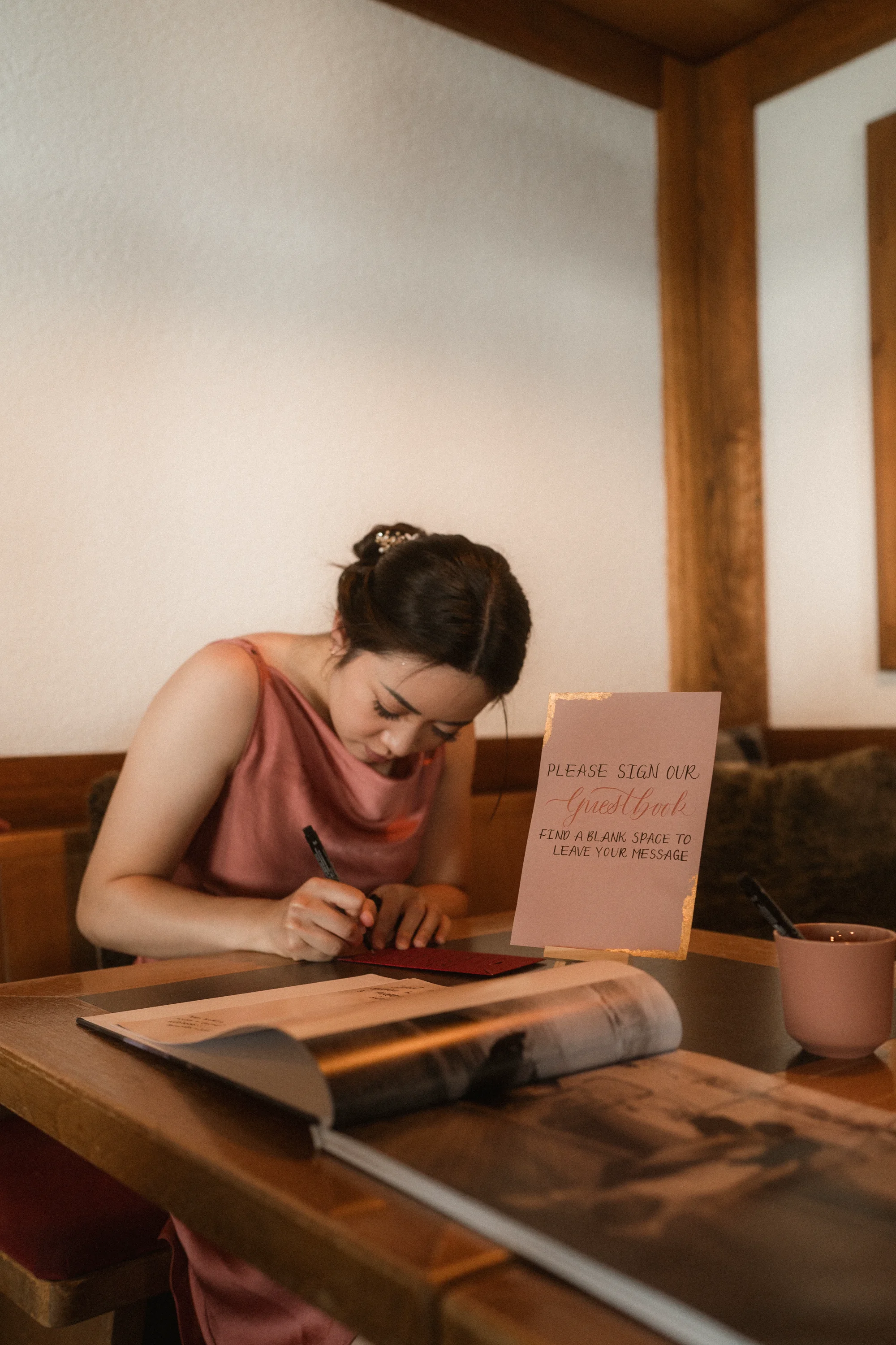Calligrapher hand-lettering a wedding table card