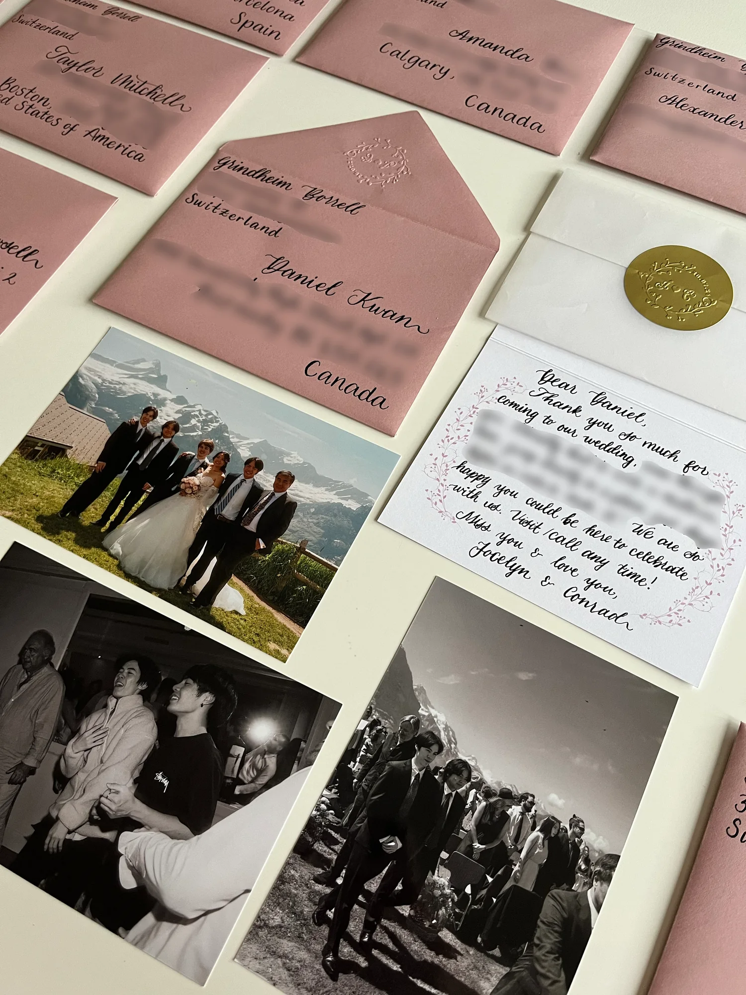 Hand-lettered guest envelopes displayed with wedding photographs and a thank-you note