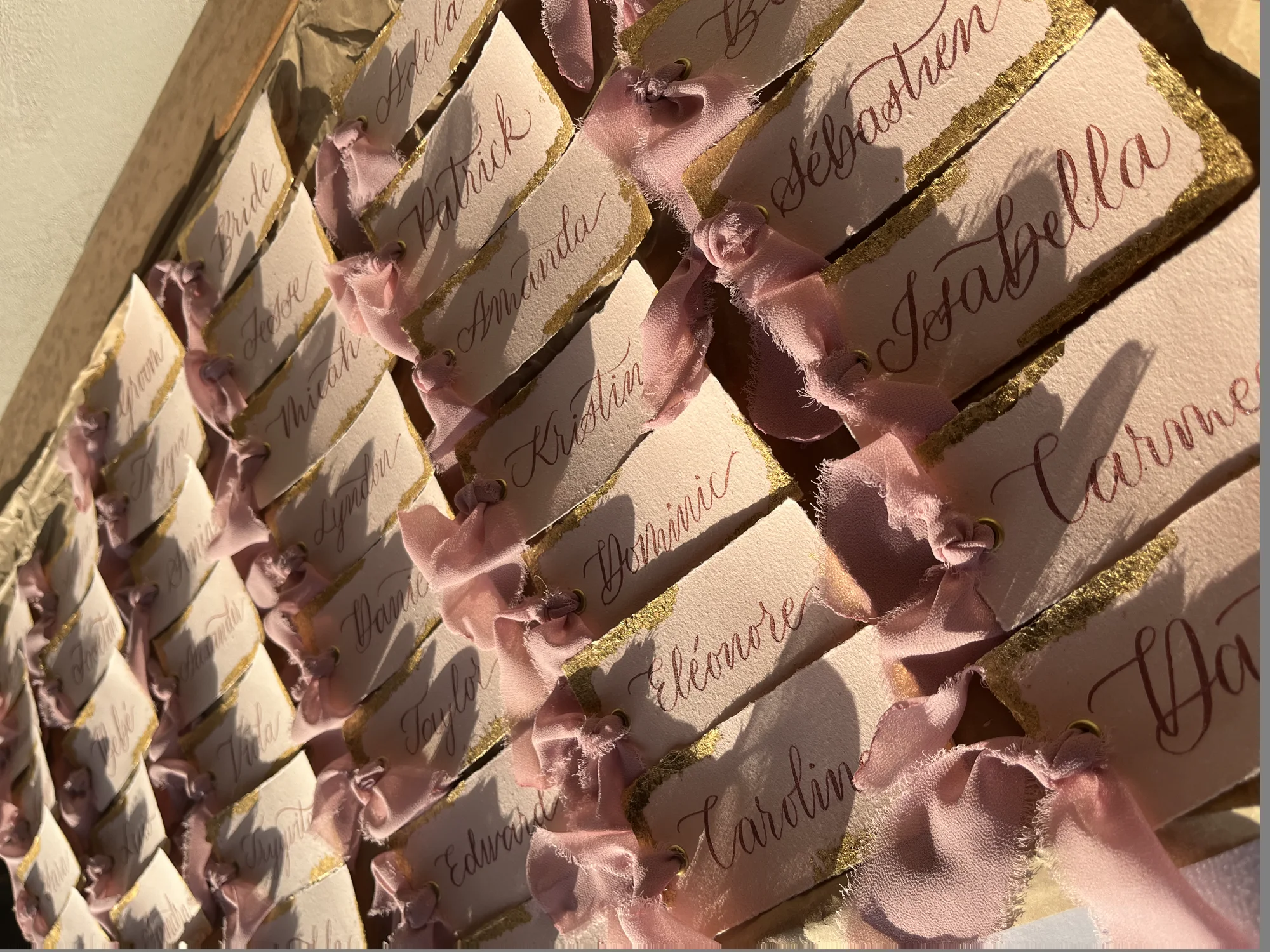 Hand-lettered place cards tied with blush ribbon