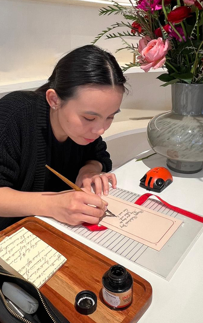 Calligrapher hand-lettering a personalised Valentino card live at an event