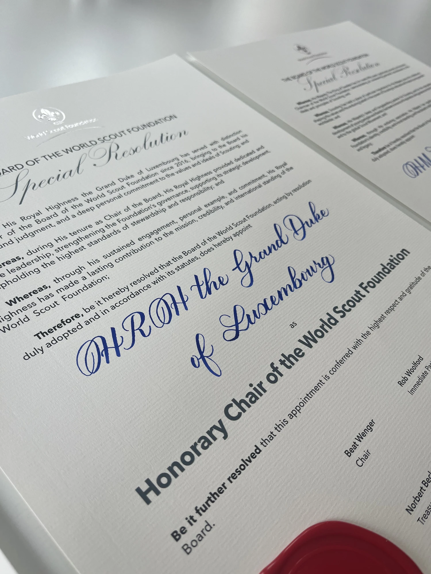 Formal World Scout Foundation board resolution with blue hand-calligraphed lettering